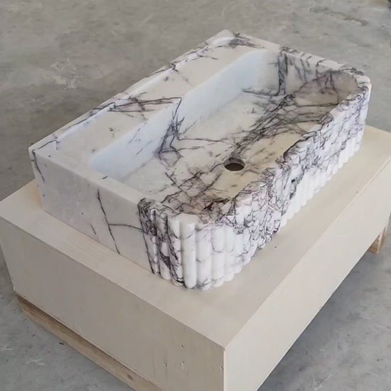 360-degree view of handcrafted Lilac marble fluted sink – showcasing natural lilac veining, ribbed front design, and smooth honed finish for luxury bathroom interiors.