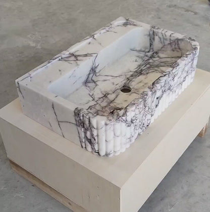 360-degree view of handcrafted Lilac marble fluted sink – showcasing natural lilac veining, ribbed front design, and smooth honed finish for luxury bathroom interiors.